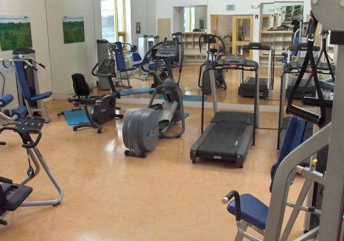 Fitness center with exercise equipment at The Enclaves at Packer Park apartments in Philadelphia